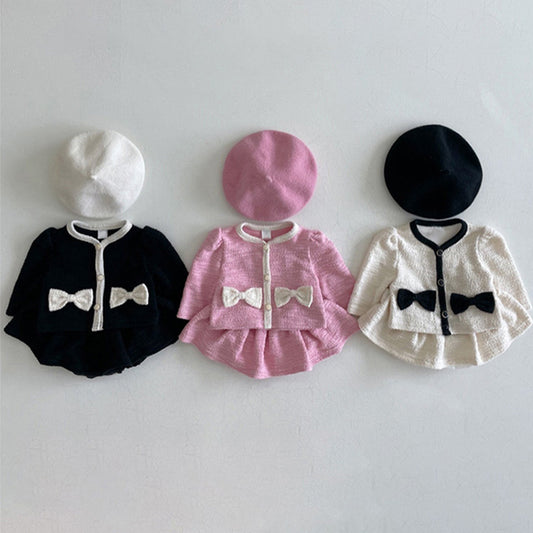 Three toddler outfits by Toddleverse featuring matching berets and bow-adorned cardigans in black, pink, and white